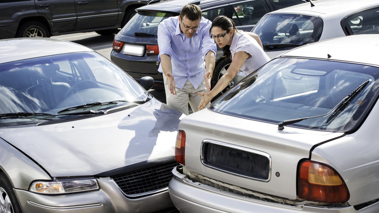 Two people arguing after a parking lot crash