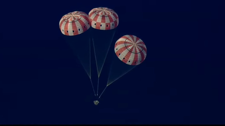 The Orion capsule "Integrity" drifts down towards the Pacific Ocean under three parachutes on April 10, 2026