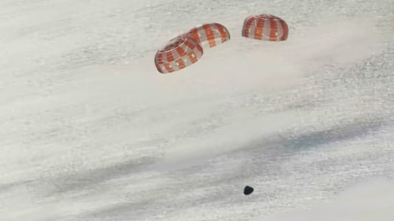 The Orion capsule "Integrity" drifts down towards the Pacific Ocean under three parachutes on April 10, 2026