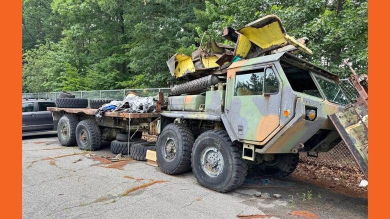 An Oshkosh military truck with trailer