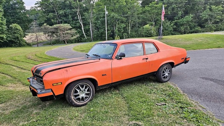 An orange Chevy Nova in rough shape