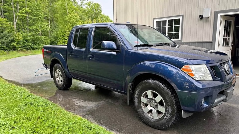 A blue four door Nissan Frontier