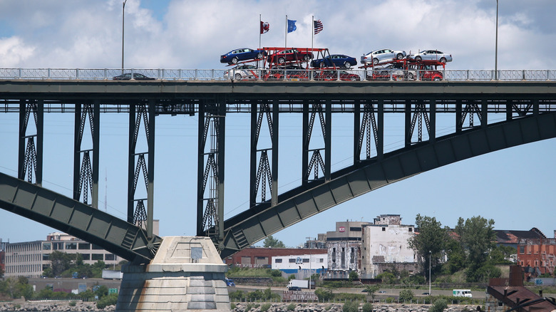 A car carrier crosses the Peace Bridge over the Niagara River on the U.S.-Canada border on June 3, 2013 in Buffalo, New York.
