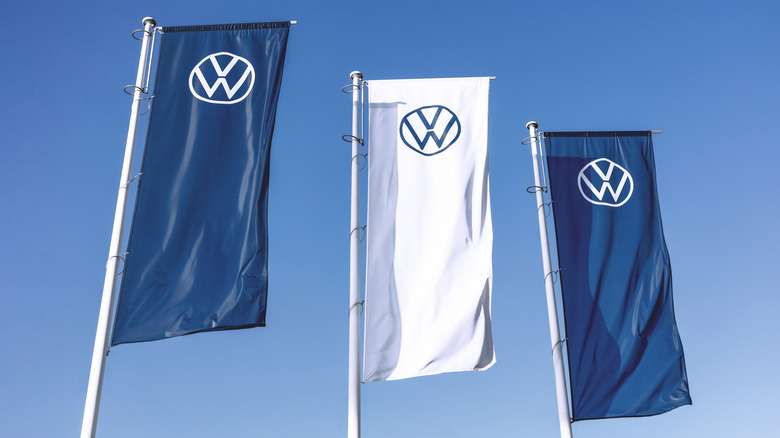 Poznan, Poland - September 28, 2023. Volkswagen logo on flags waving against a blue sky background.  by: canon_photographer