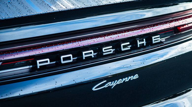 Apex, North Carolina - August 24 2025: Porsche Cayenne Luxury Performance SUV Front Rear Crest Emblem Logo Detail  by: PJ McDonnell