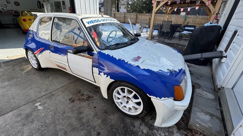 A blue and white liveried Peugeot 205 GTI