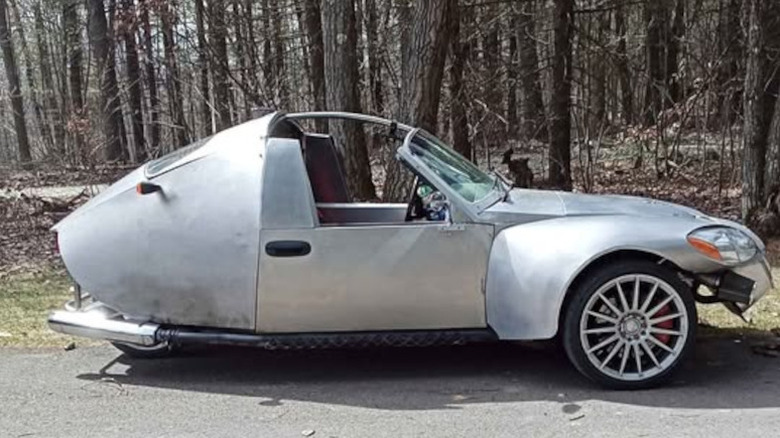 Some sort of silver vehicle, clearly a three-wheeler