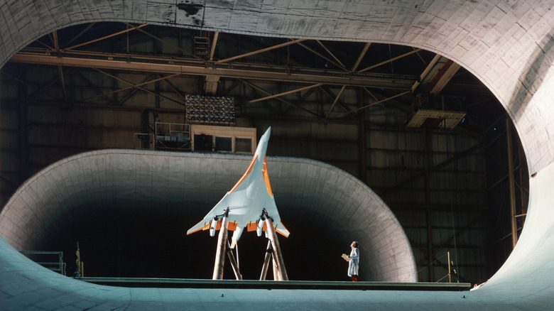 A model supersonic plane in a wind tunnel test chamber