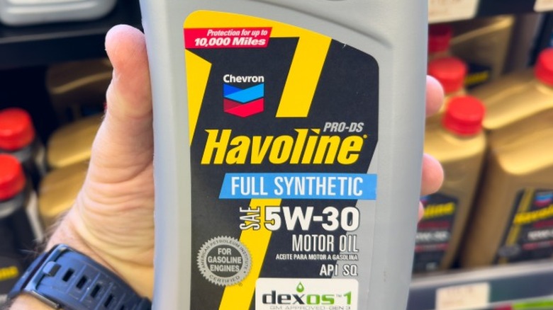 Havoline synthetic motor oil bottle held in hand.