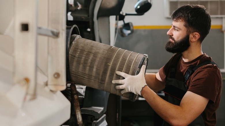 Mechanic replacing air filter