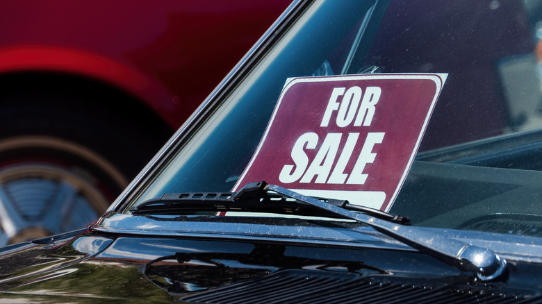 For sale sign in the windshield of a car