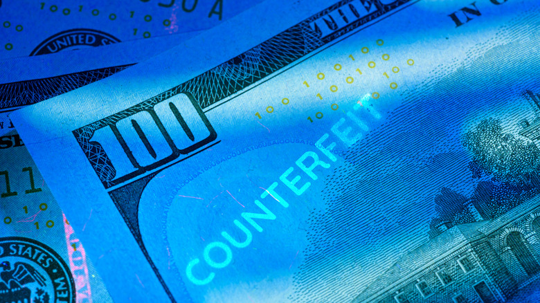 Close-up of counterfeit money under UV light