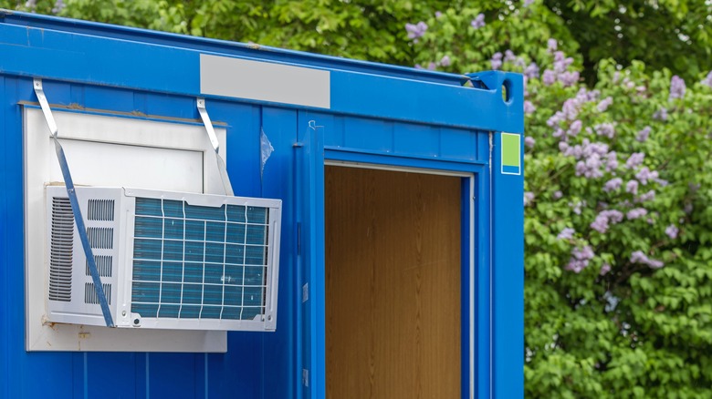 An image of a wall mounted HVAC unit in the side of a cargo container.