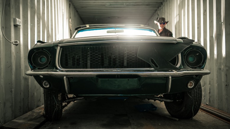 A vehicle inside of a cargo container.