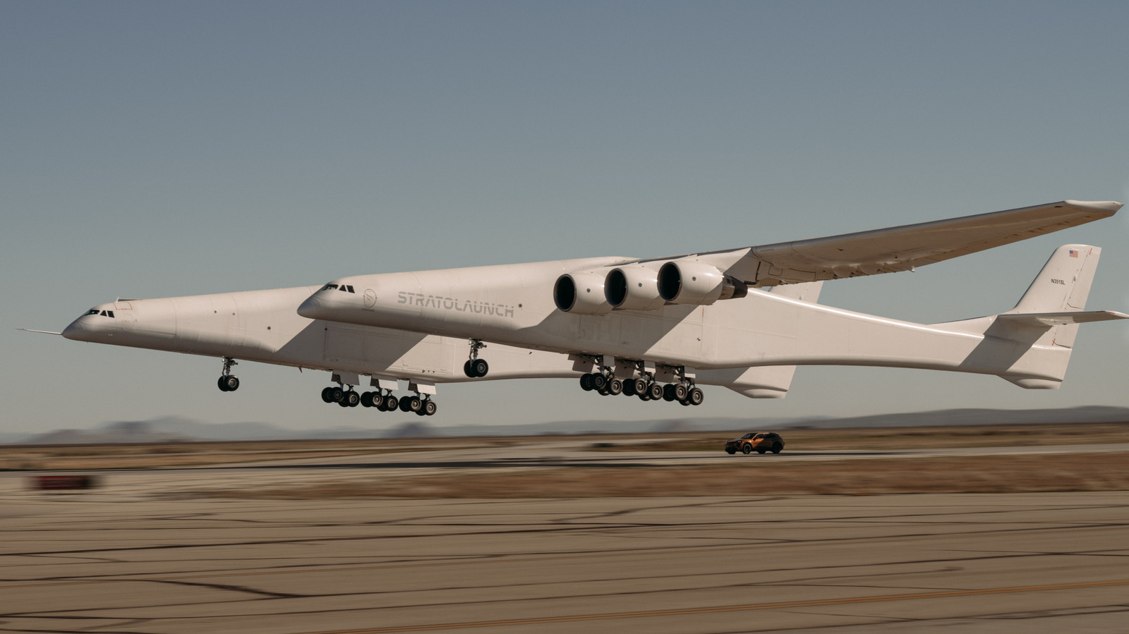 Watch A Porsche Cayenne Turbo Electric Drive Underneath The World's Largest Aircraft While It Takes Off