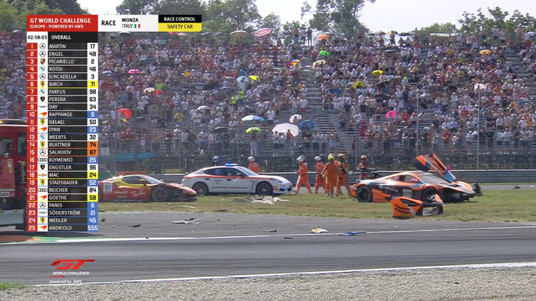 Safety workers and rigs attend to the crashed remains of the #51 AF Corse Ferrari and the #59 Garage 59 McLaren involved in the incident at Monza.