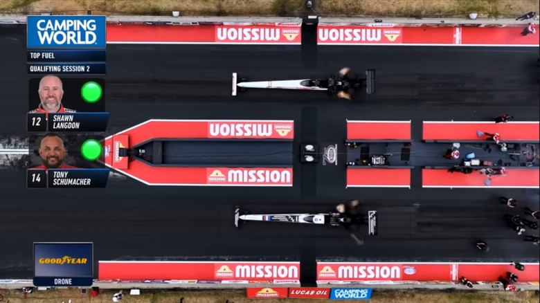 A top-down view of Shawn Langdon's top fuel dragster (top lane) and Tony Schumacher's dragster (bottom lane) as they take off for their run at the Southern Nationals.