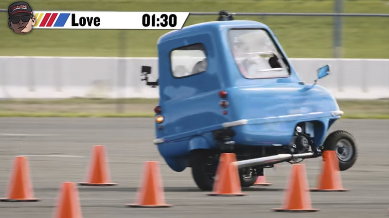 Jesse Love, 2025 NASCAR O'Reilly's Auto Parts series champion puts a Peel P50 on two wheels trying to navigate it around cones in the sorta high speed course.