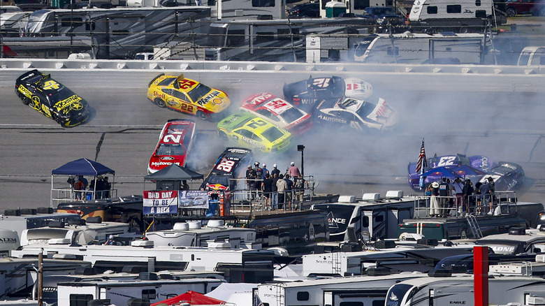 The aftermath of the big crash at NASCAR's Talladega race with the No. 45, 22, 21, 2, 54, 12, 41, 23 cars all wrecked, still moving across the track.