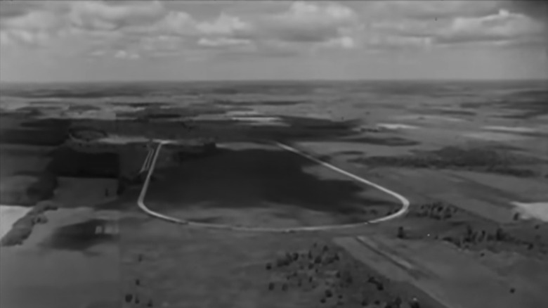 A screenshot from the black and white film of Studebaker's proving grounds from the air.
