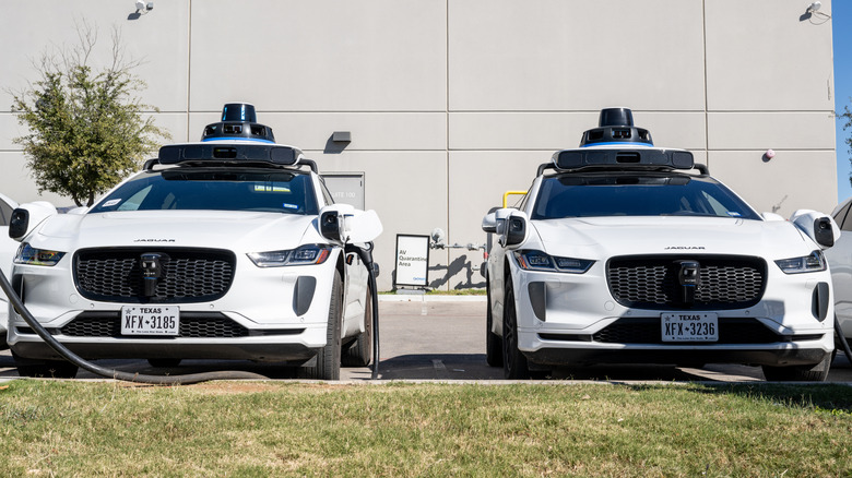 Waymo vehicles charge at a lot on January 15, 2026 in Austin, Texas.