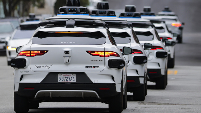 A line of Waymo robotaxis drives through North Beach on July 07, 2026 in San Francisco, California.