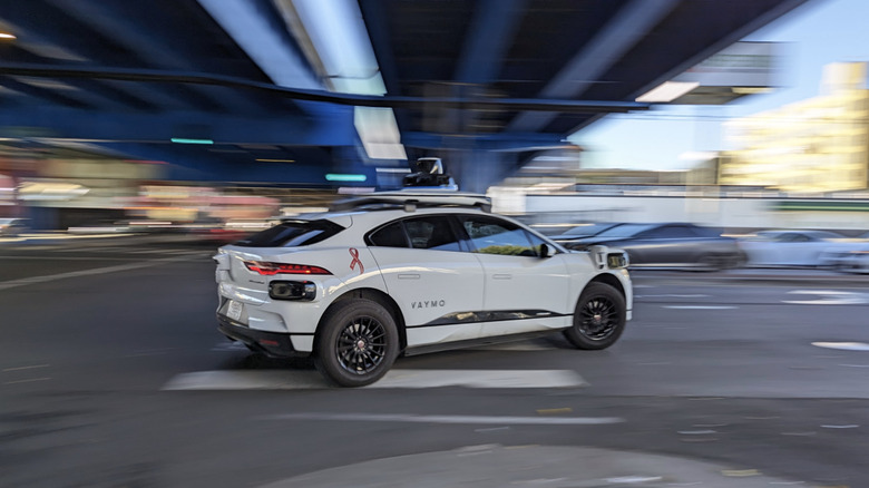A Waymo autonomous taxi driving through an intersection in San Francisco