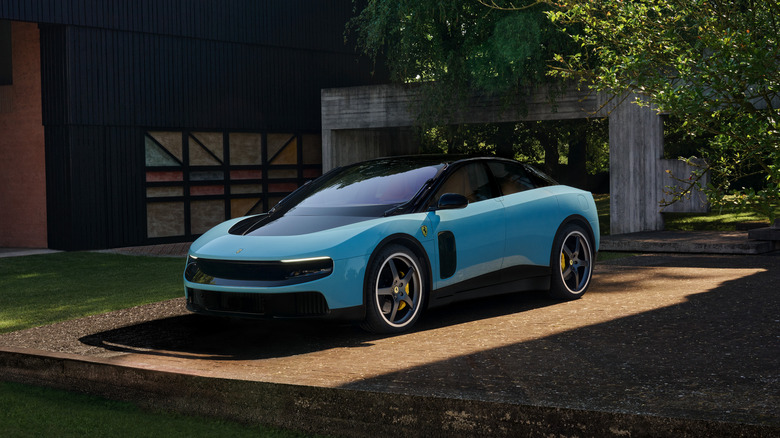 A light blue Ferrari Luce in a rustic dirt driveway