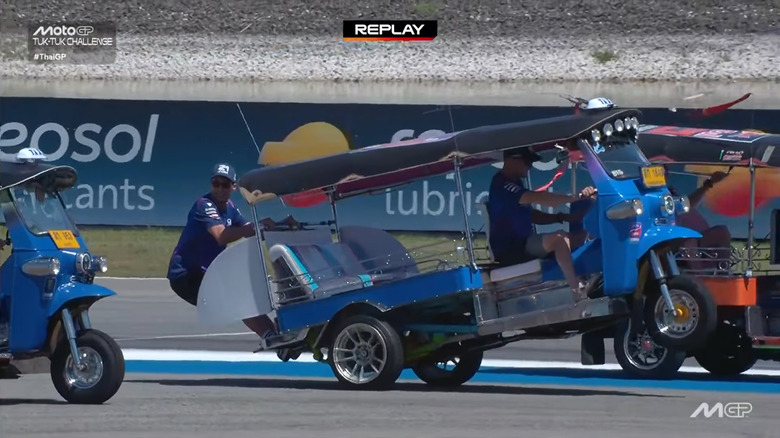 Toprak Razgatlioglu wheelies a tuk-tuk with Jack Miller on the back