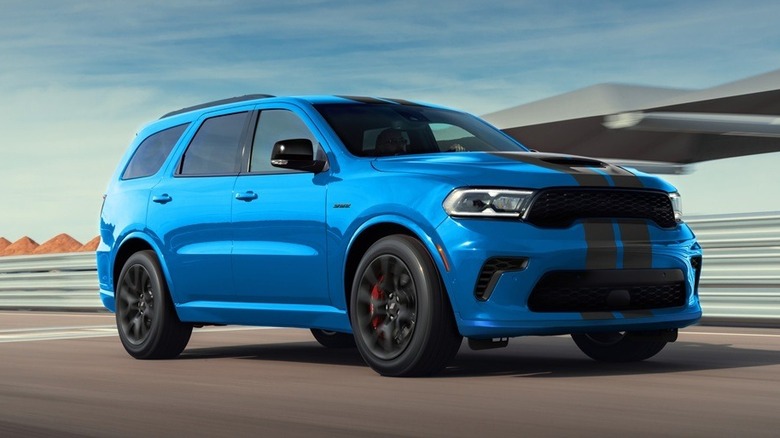 Blue Dodge Durango R/T 392 driving down a road on a sunny day