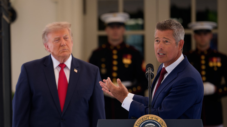 Sean Duffy has a worried look as he tries to explain something while pointing his hands to President Donald Trump who looks like he's either going to fall asleep or sorta hates Duffy.