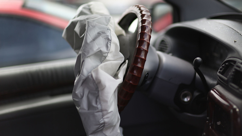 A deployed airbag inside of a vehicle