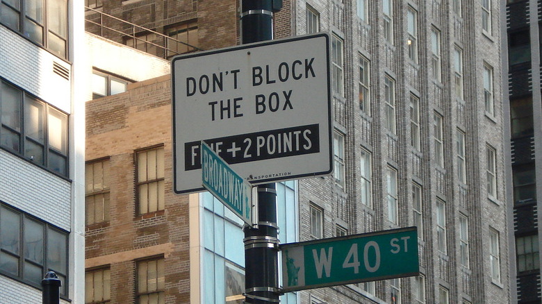 A "Don't Block The Box" sign on a post at the corner of Broadway and 40th Street in Manhattan