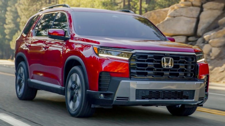 Front 3/4 view of 2026 Honda Passport on the road.