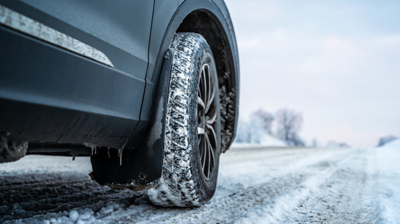 Front car tire on a snowy road.