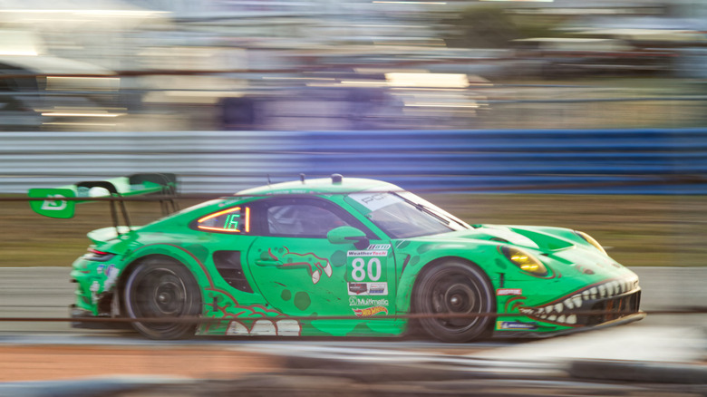 The toothy-grinned race car of AO Racing's No. 80 Porsche GT3-Rawr tackling the bumps at IMSA's 12 Hours of Sebring in 2023.