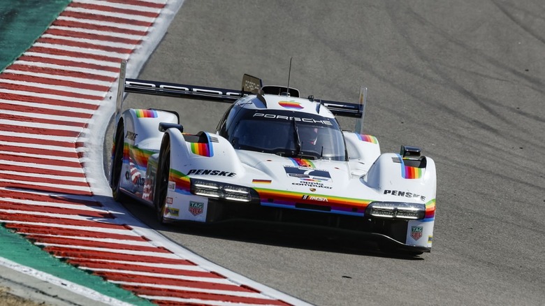 A porsche 963 racecar on the Laguna Seca racetrack