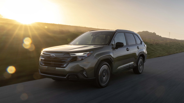 A 2026 Subaru Forester Sport Hybrid riding at sunset on an open rural road