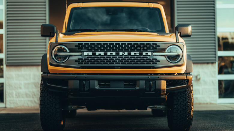 A front-end view of a yellow Ford Bronco SUV.