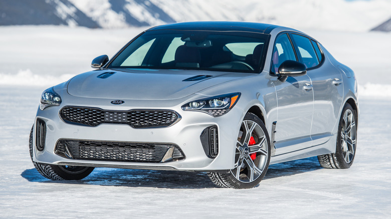 A front 3/4 view of a silver 2021 Kia Stinger parked on a snowy surface