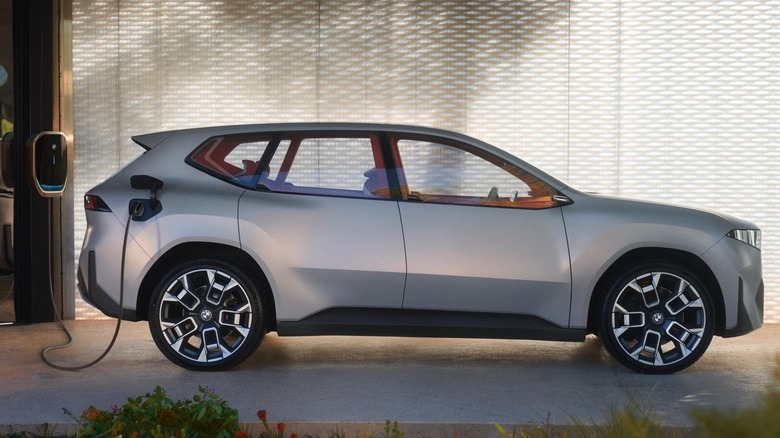 A side shot of a silver BMW Neue Klasse X,charging.