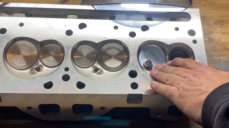 A closeup of the combustion chambers of an aftermarket aluminum Pontiac V8 head.