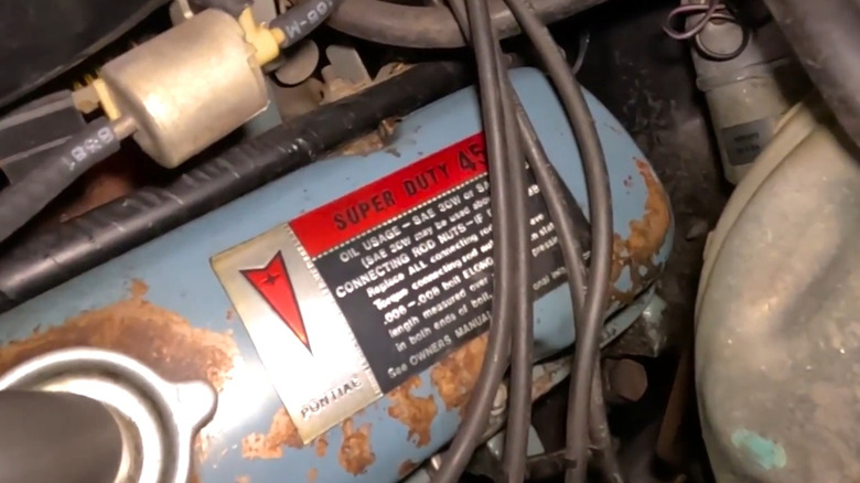 The information sticker on the valve cover of a 1974 Pontiac Trans Am Super Duty 455.