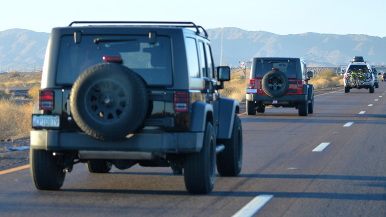 Jeep Wranglers driving on a desert highway