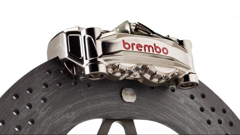 A machined-aluminum Brembo brake caliper clamped over a carbon-ceramic disc brake.