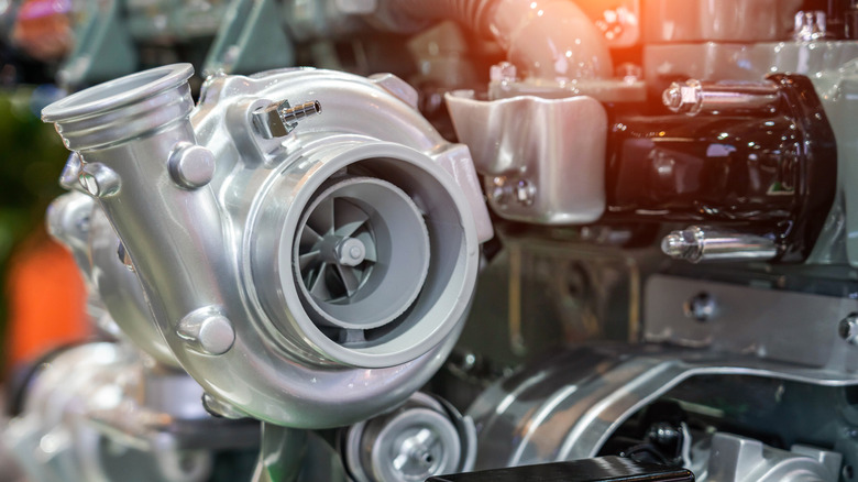A big turbo mounted to the side of an engine