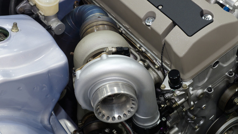 A turbocharger mounted to a engine.
