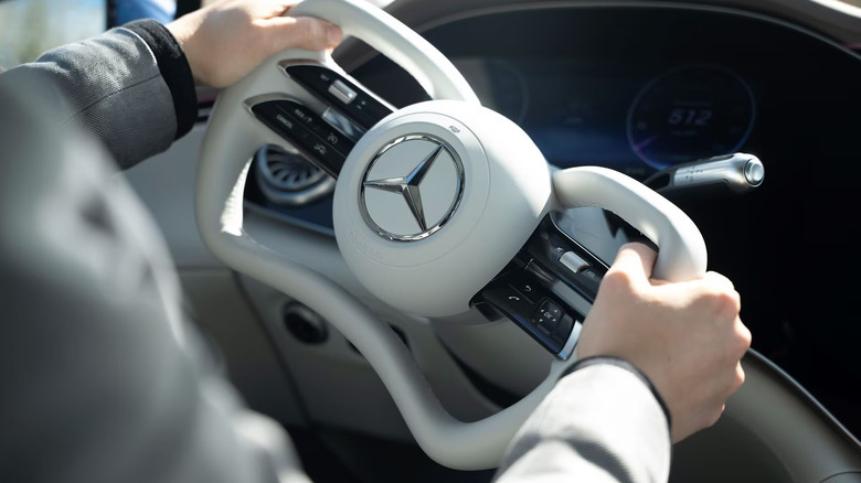 A person using a Mercedes-Benz steering with Steer-by-Wire technology