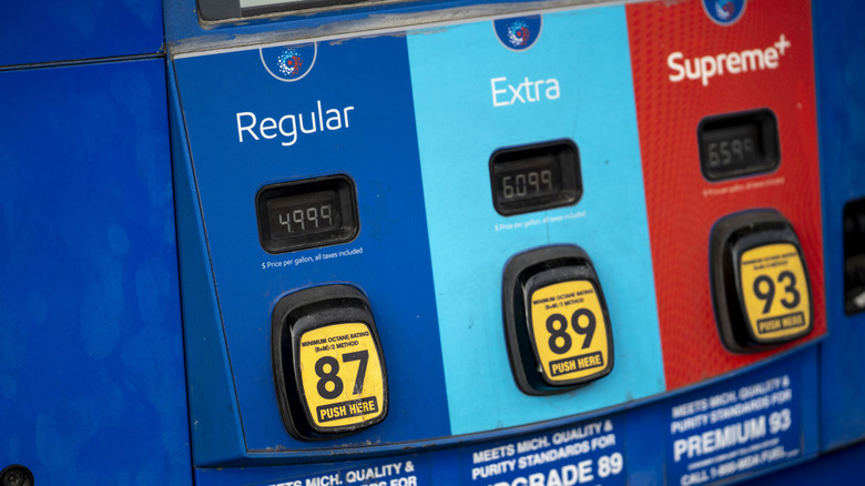 Three fuel pumps showing the price of gasoline
