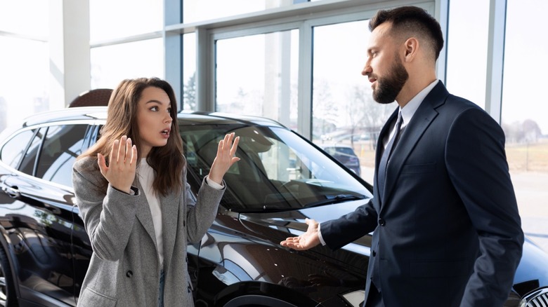 A woman arguing with car salesperson